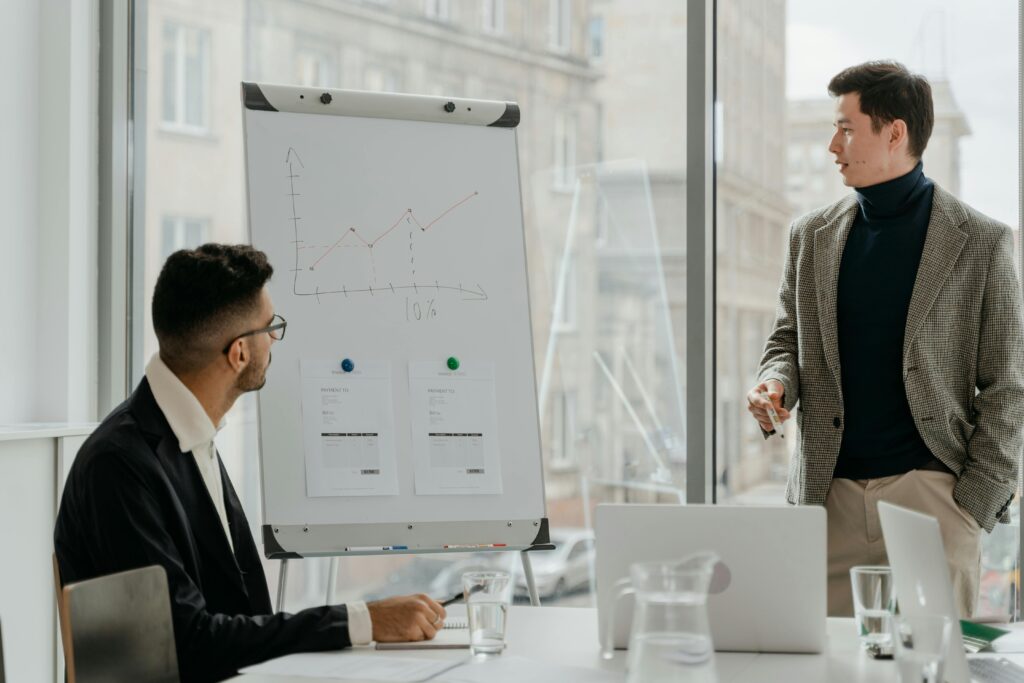 Professionals discussing a business chart in a modern office.