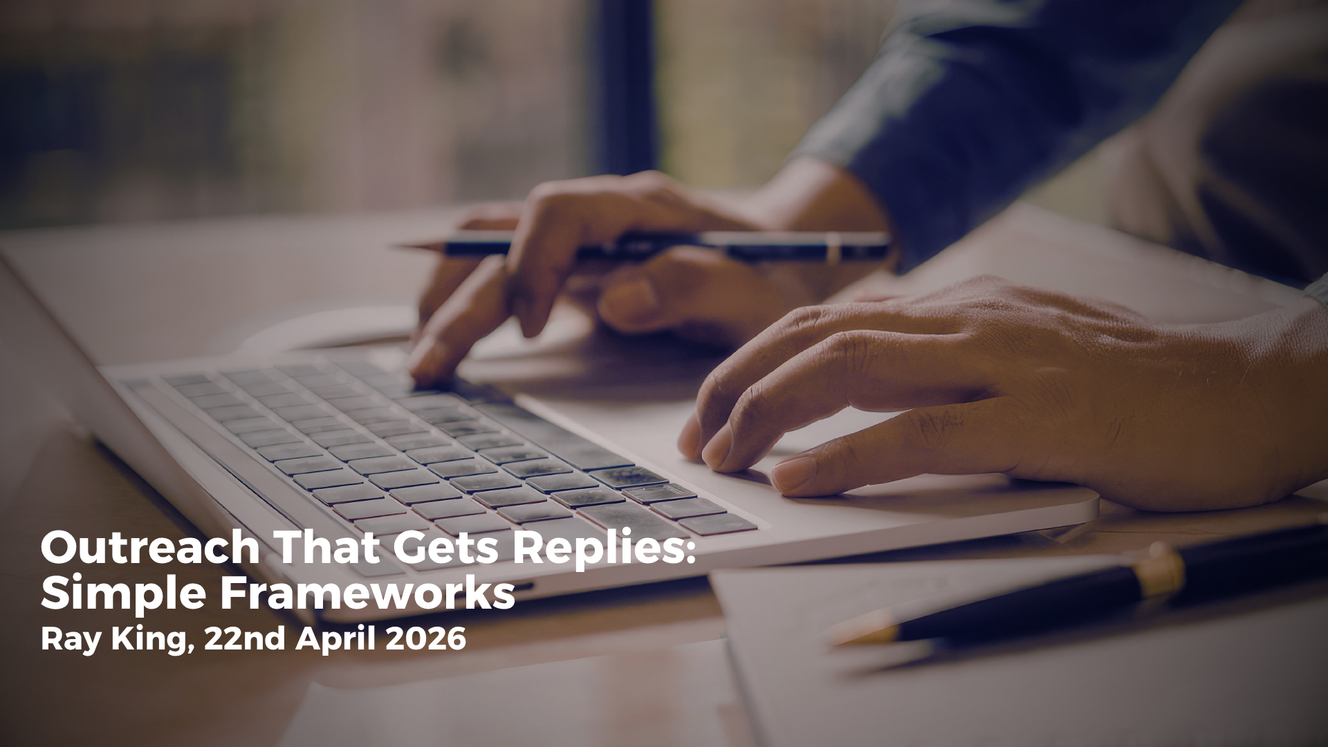 Sales professional writing a concise outreach email at a tidy desk